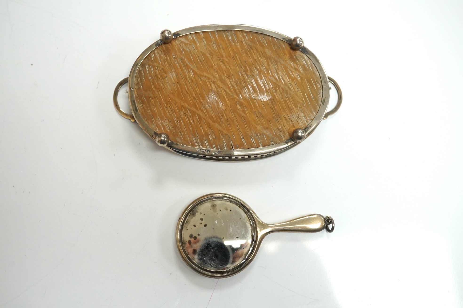 A collection of miniature silver including a three piece tea set and two handled tray by Saunders & Shepherd, Birmingham, 1904, tray 9.8cm, together with pepperettes including saucepan, candlesticks, hand mirror, etc. Co